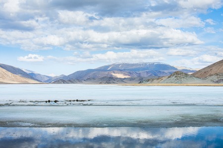 cold iced lake with great mountainsの写真素材