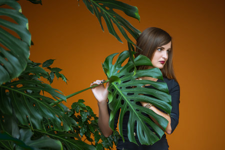 pretty girl holding by hand stalk of palmの写真素材