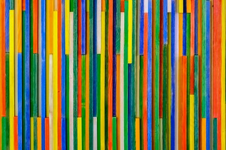 Background of abstract vertical multi colored wooden strips.の写真素材