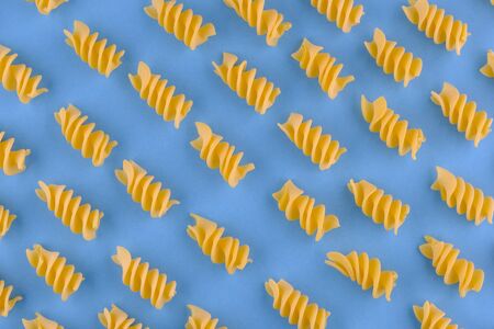 Giant fusilli pasta on blue background. Close up viewの写真素材