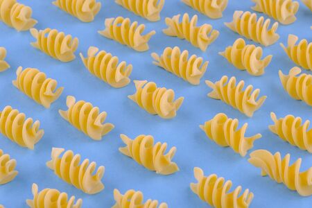 Giant fusilli pasta on blue background. Close up view.の写真素材