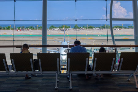 Thailand, Phuket - 09.05.18. Family,  man and kids together sitting and waiting in airport for departure.のeditorial素材