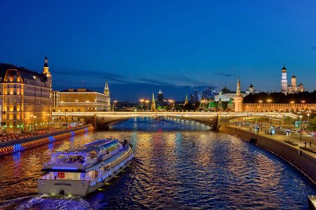 Moscow, 23 june 2021: Night city landscape with view at moscow river embankment and Moscow Kremlin.
