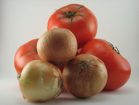 Tomatoes and onions on a white background.の写真素材