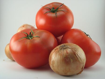 Tomatoes and onions on a white background.の写真素材