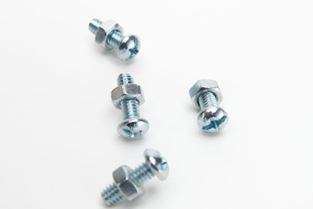 head bolts attached to hexagonal nuts isolated on white