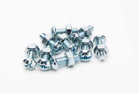 collection of screw bolts attached to hex nuts isolated in whiteの写真素材
