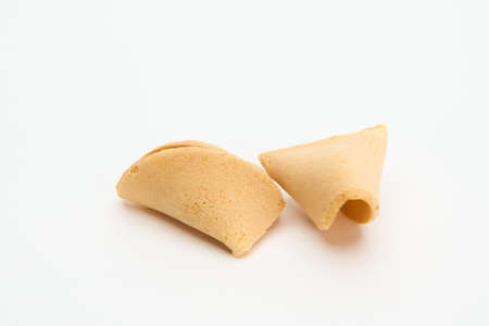 broken fortune cookie isolated on whiteの写真素材