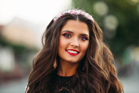 Beautiful young girl wearing lovely diadem and smiling at camera.