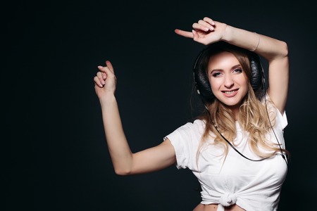 Happy pregnant mom dancing and rising up by hands.の写真素材