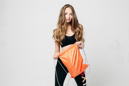 Sporty girl in sportwear posing with rucksack.の写真素材