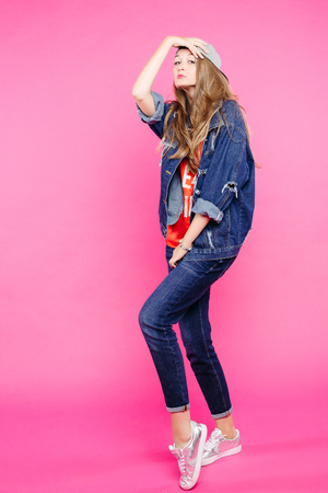 Stylish girl wearing jeans outfit dancing at studio.の写真素材