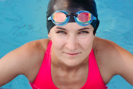 Close up of positive and beautiful woman in swimming pool.の写真素材