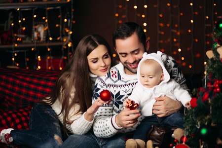 Loving parents with baby at Christmas.の写真素材
