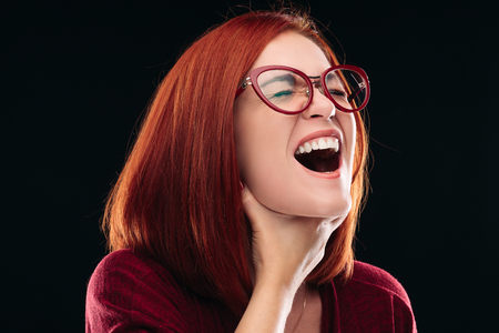 Woman in spectacles having sore throat, she holding hand on neck.の写真素材