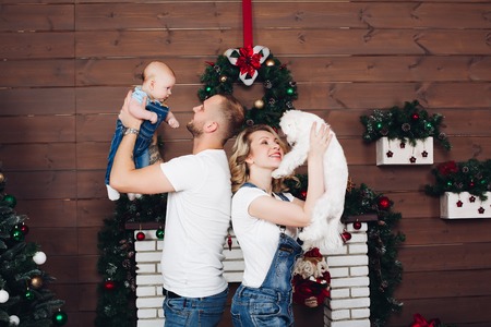 Positivity family posing together near fireplace and presents for Christmasの写真素材