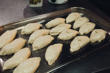 Fresh making baked flavored buns set made on big metallic plate.の写真素材