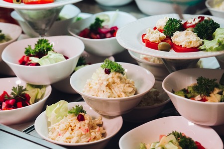 Many round plates with tasty vegetables dish of salads in restaurant.の写真素材