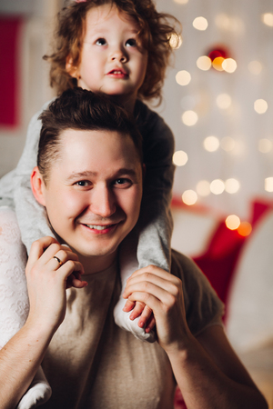 Portrait of loving father with daughter on his shoulders.の写真素材