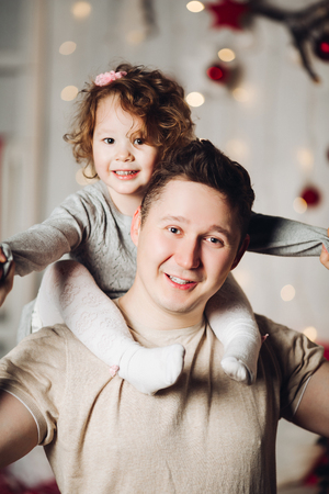 Portrait of loving father with daughter on his shoulders.の写真素材