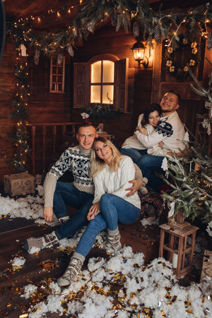 Christmas portrait of two couples. beautiful houseの写真素材
