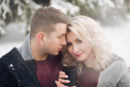 Couple boyfriend and girlfriend holding cup with coffee.