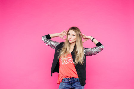 Swag and confident teenage girl dancing at pink studio.