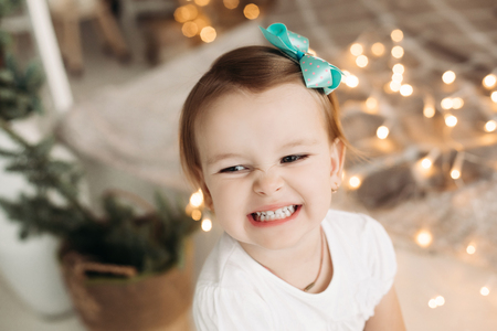 Cheerful little girl looking at camera, posing.の写真素材