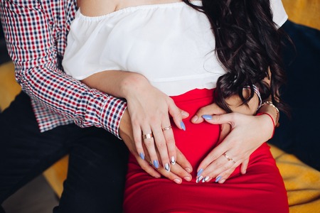 Husband and wife embracing pregnant belly.Waiting for a baby concept.の写真素材