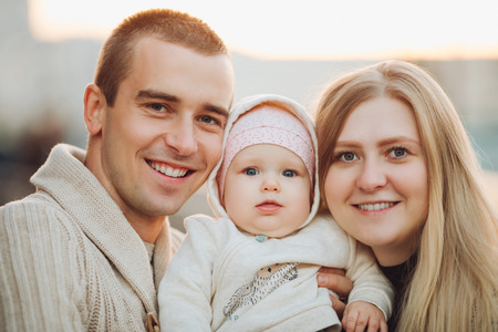 Young happy family smiling at camera and standing together.の写真素材