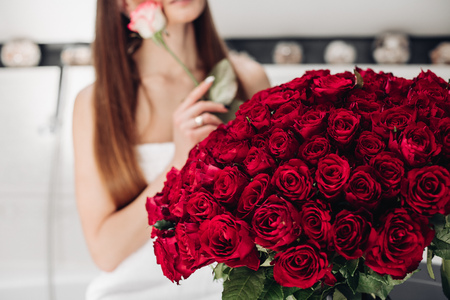 Gorgeous bouquet of red roses with green leaves in close up.の写真素材