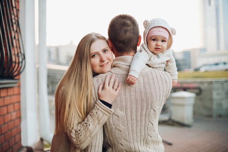 Young happy family smiling at camera and standing together.の写真素材