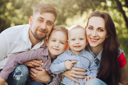 Portrait of young happy family kissing his little son.の写真素材