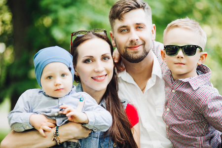 Portrait of young happy family kissing his little son.の写真素材