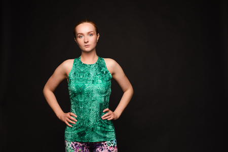 Strong red haired woman in sport uniform posingの写真素材