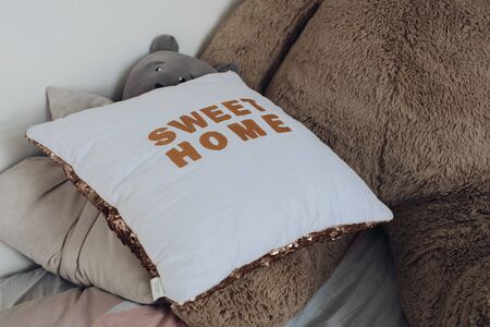 Comfortable pillows and toys of children lying on bedの写真素材