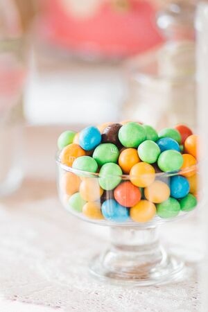 Colorful delicious candies staying in plate on tableの写真素材
