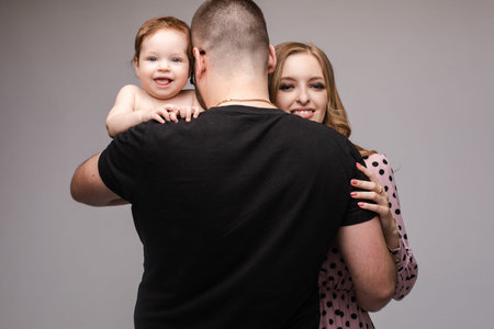 Portrait of happy family from three people posing at camera.