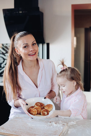 Happy mother and daughter showing baked curd fritter