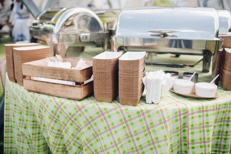 A table with served food and containers.の写真素材