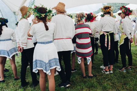 Belarus Minsk 26 07 2019 People in floral wreath at festival.