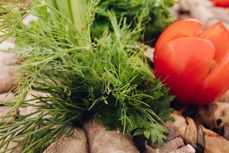 Closeup fresh green parsley, red juicy tomato servicedの写真素材