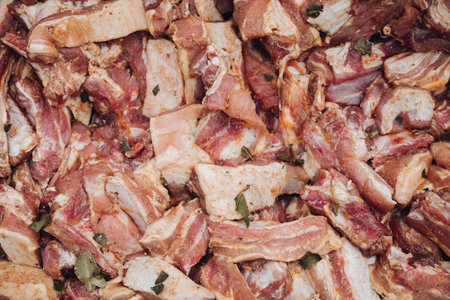 Many raw piece of fresh meat in marinade ready to cooking barbecue close-up