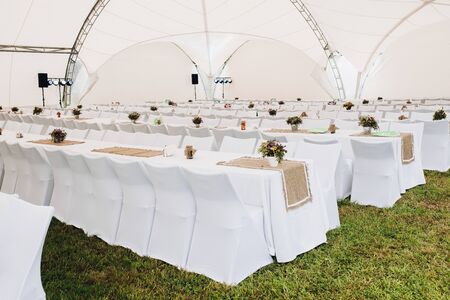 Catering with white long tables and chairs.の写真素材