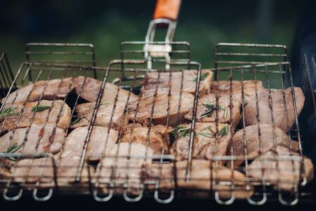 Meat barbecue on grill.Close-up of meat preparing on BBQ grill equipment outdoors. BBQ party concept.の写真素材