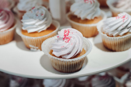 Close-up beautiful fresh appetizing cupcake decorated fresh white whipped cream serving on big plate
