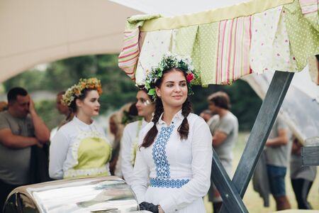 Close-up waiter female wearing traditional Uzbek dress hand putting grilled piece of meatのeditorial素材