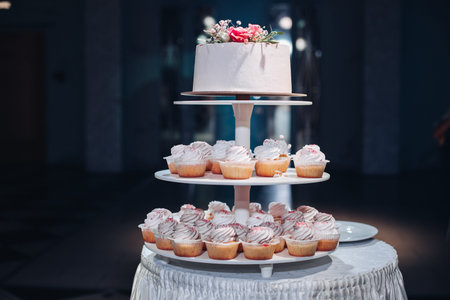 Beautiful wedding cake with flowers on tableの写真素材