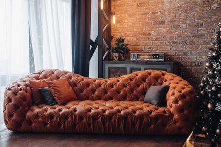 Red leather sofa in beautiful loft room.の写真素材