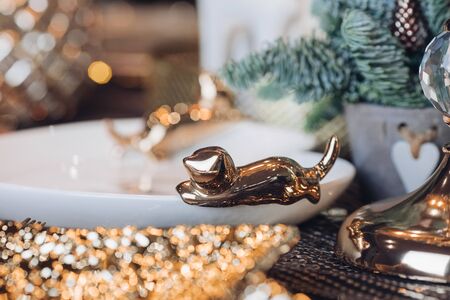 Close up of white plate decorated with a golden figurineの写真素材